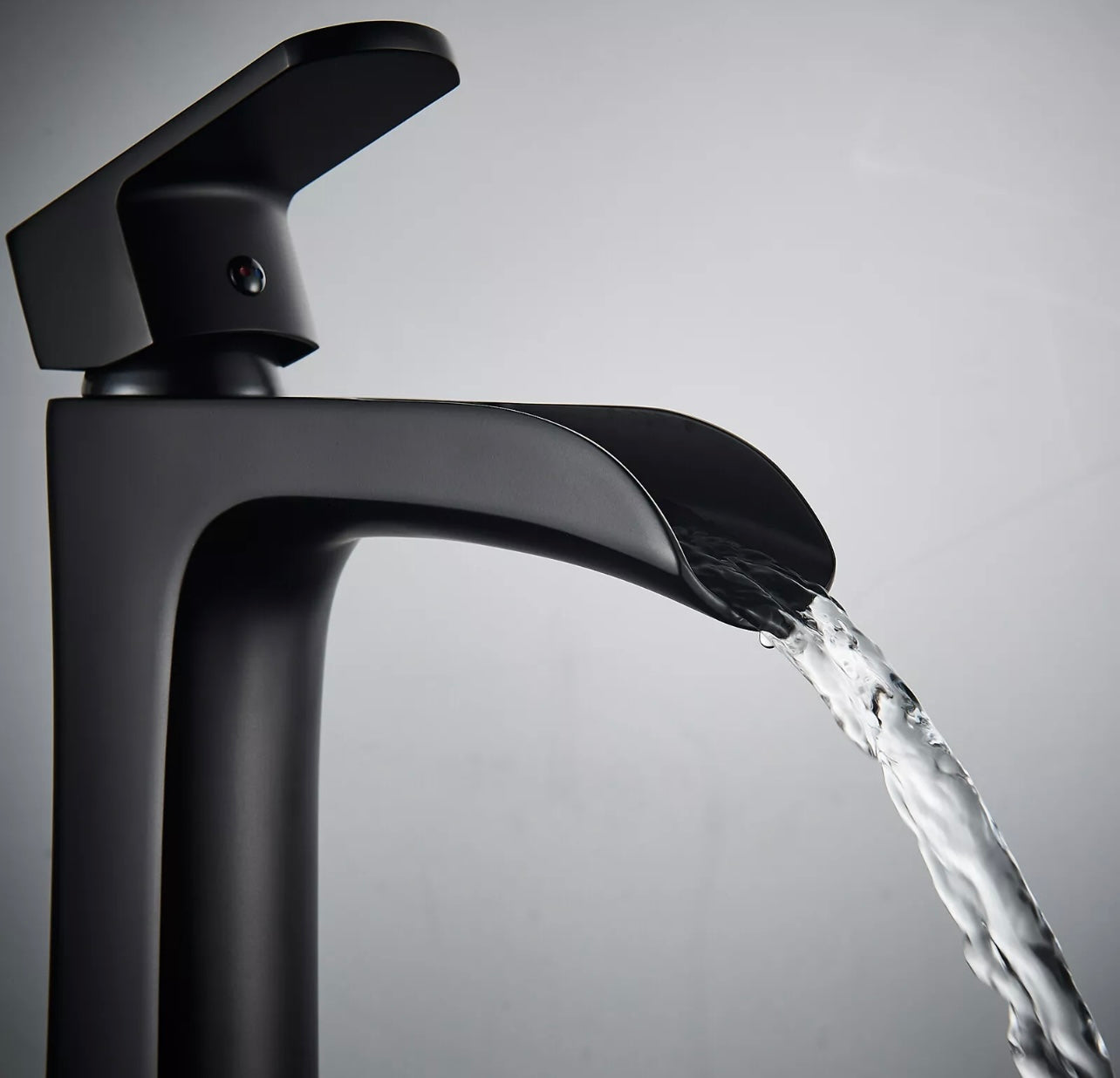 Matte black waterfall vessel faucet